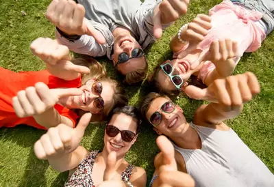 Group of friends thumbs up