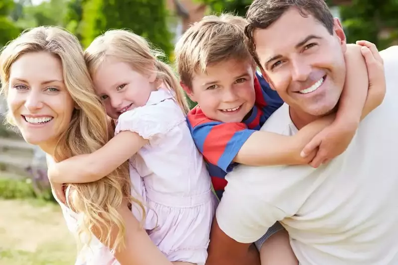 family smiling at camera