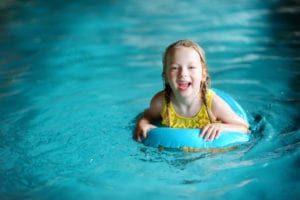 girl floating in a pigeon forge cabin indoor pool